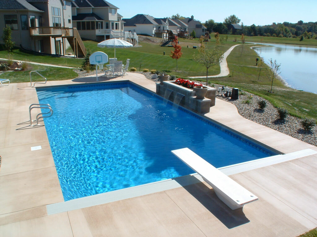 rectangular pool with diving board and landscaping