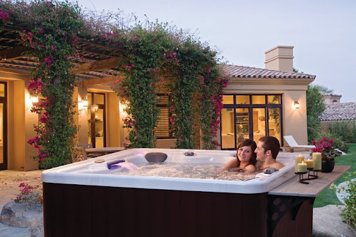 couple in a hot tub spice up date night with flowers and candles