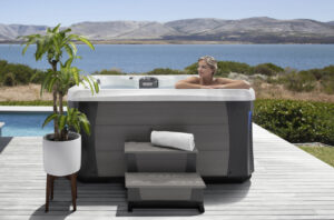 woman using her Marquis hot tub in summer