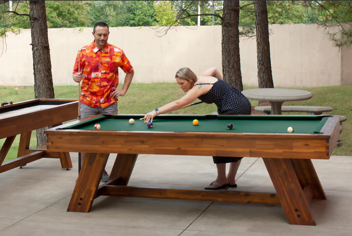 family playing on their billiards table