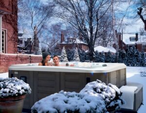 couple enjoy Marquis Spa in snow